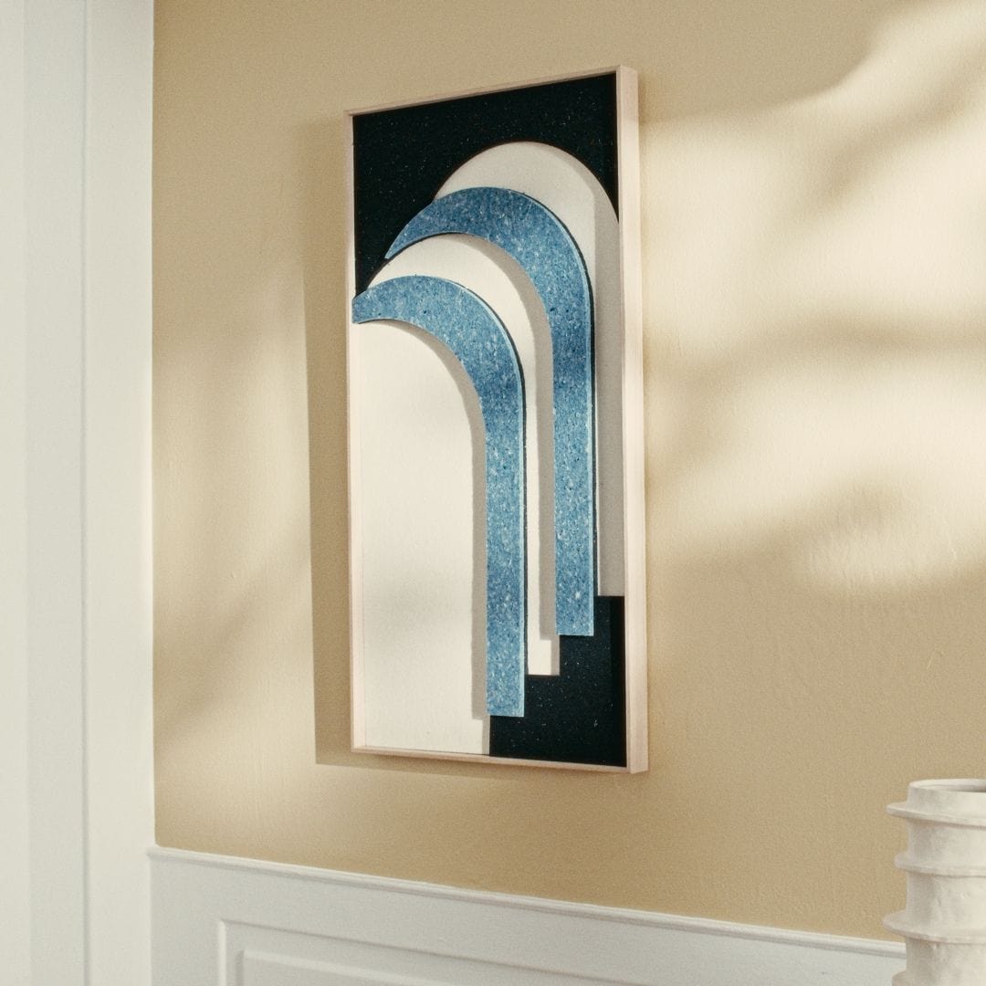 Original modern art panel with layered blue and white arches, framed in natural wood, displayed on a softly lit wall.